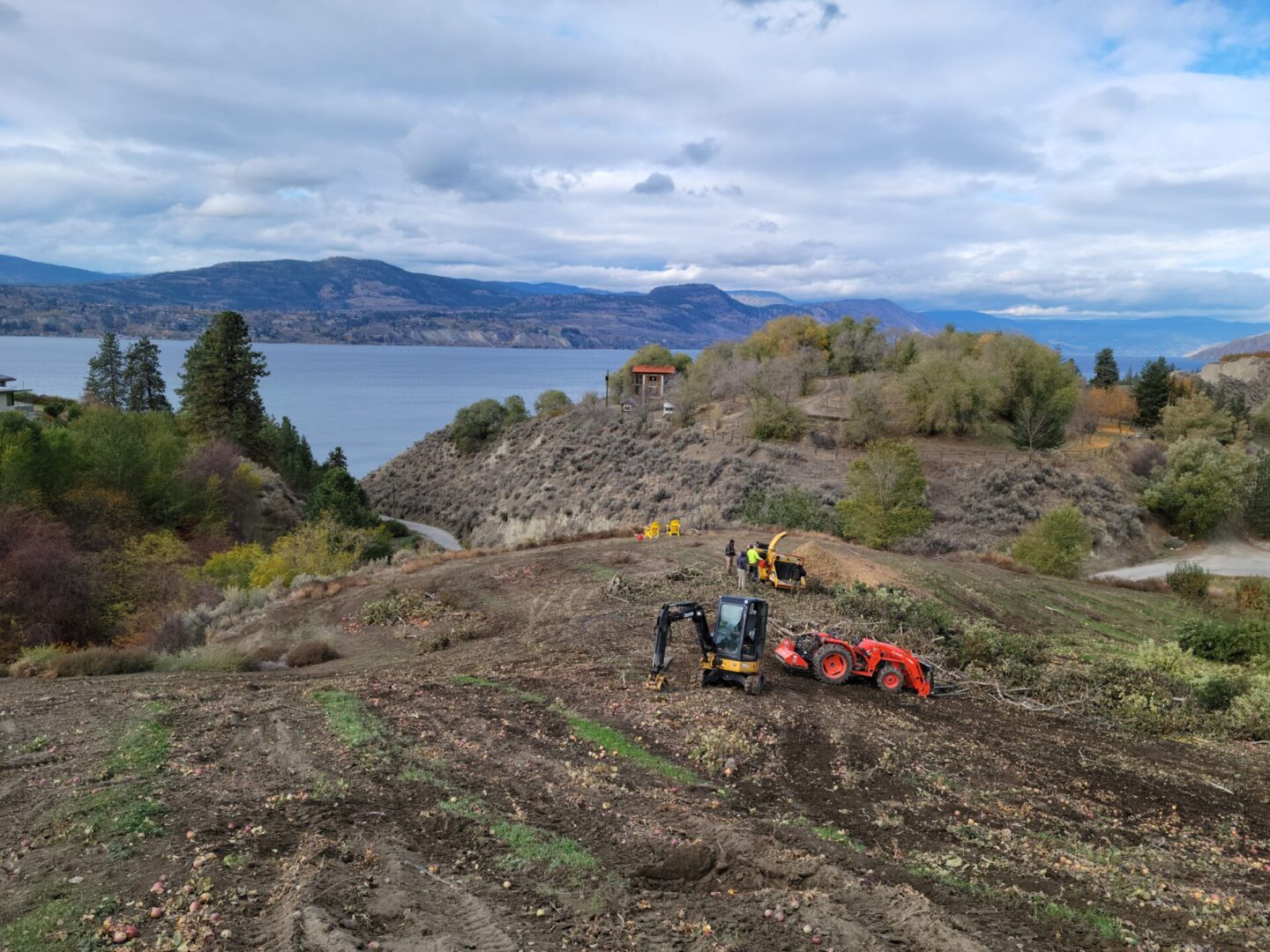 A tractor is parked on the side of a hill.