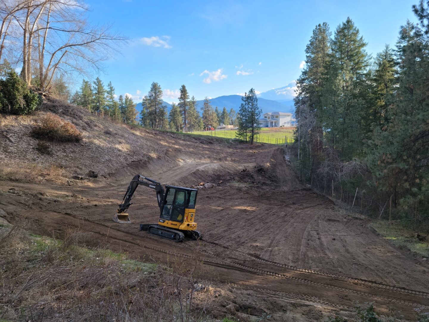 A yellow and black tractor is on the dirt