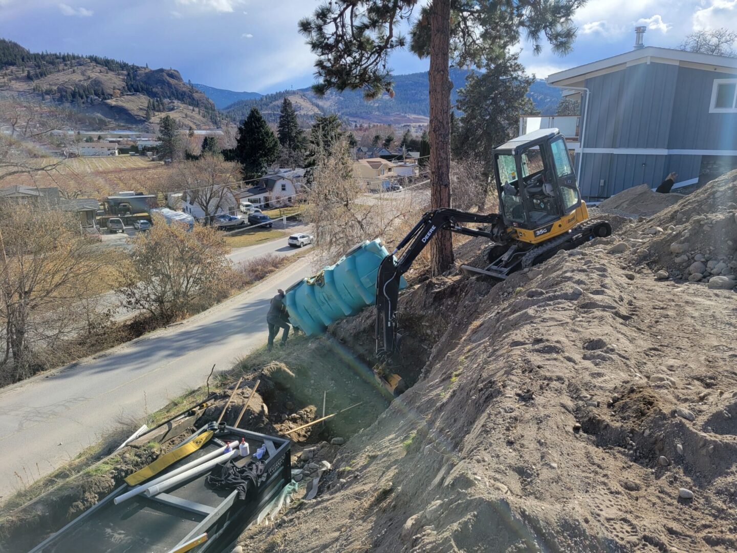 A large tree is being cut down by a tractor.