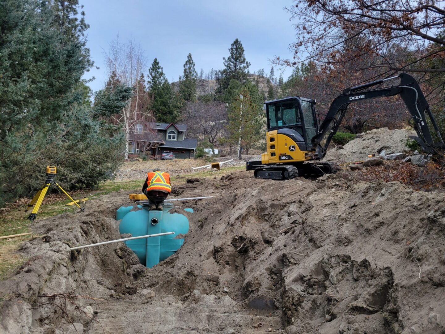 A man in a blue kayak is digging a hole