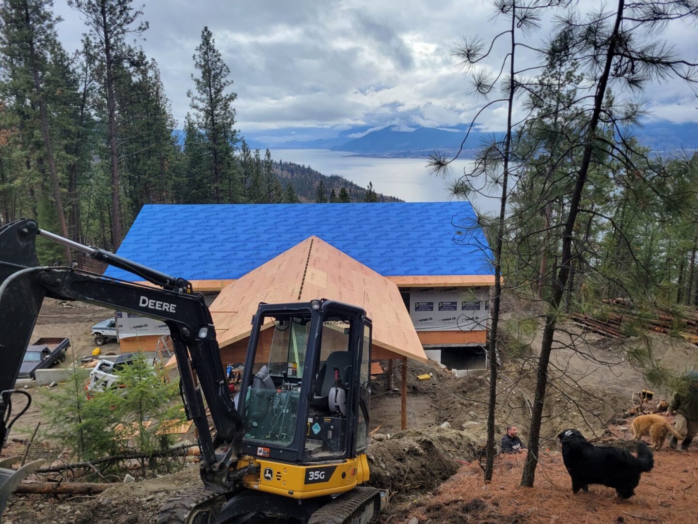 A construction site with a large blue tarp covering the roof.