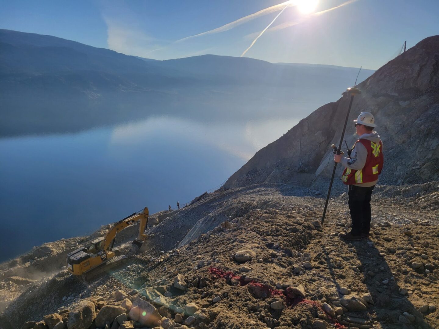 A man standing on top of a mountain with poles.