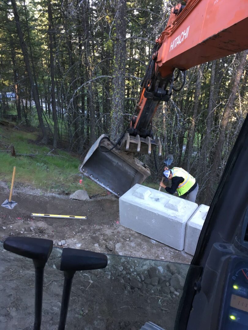 A crane is lifting a box from the ground.